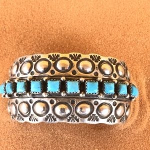 Navajo Hand Tooled Sterling Silver cuff bracelet with 12 Sleeping Beauty stones 1 1/4" wide