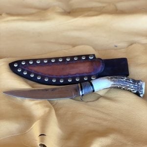 Handmade from saw blade steel with deer antler and walnut handle Comes with a beautiful Tacked sheath Left hand draw By Keith Tohannie 11 1/2"
